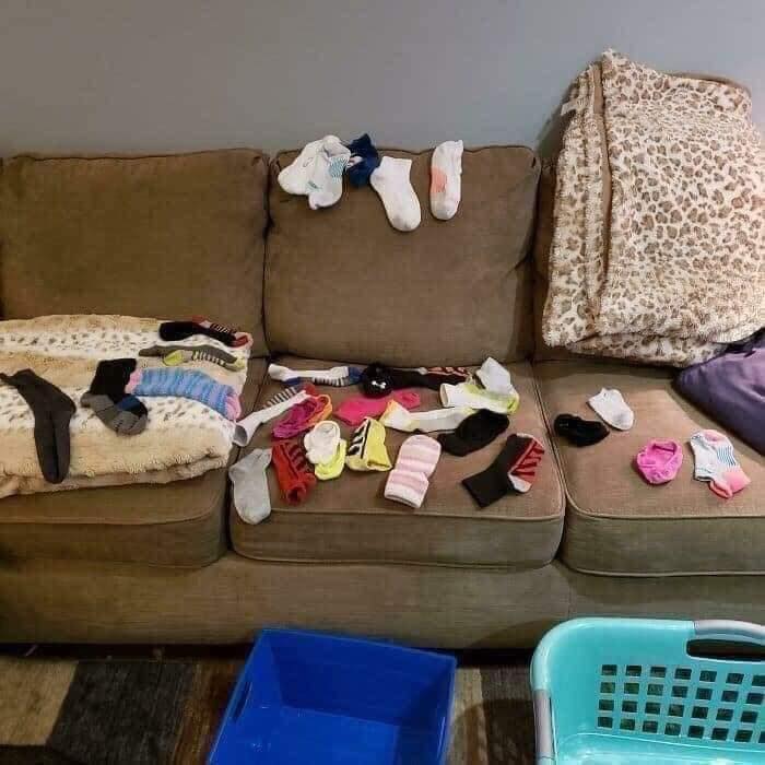 27 Terrifying Images That Show What Its Really Like To Be A Parent 4 clothes on couch