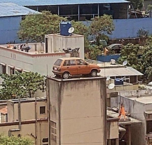 20 Photos That Raise More Questions Than Answers 3 car on building - Photos That Raise More Questions Than Answers