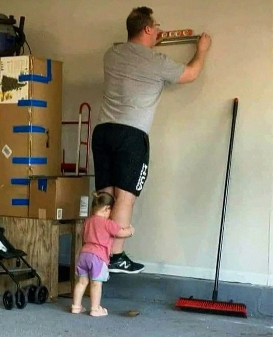 kid lifting dog