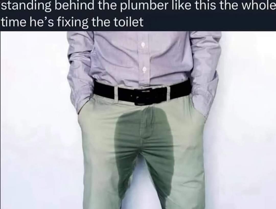 Standing behing the plumber