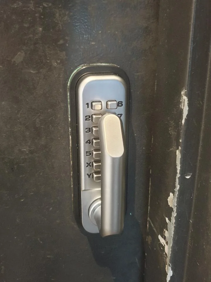 The new lock at my work has the handle placed on top of the keys making it quite difficult to input the 6+ key code to enter